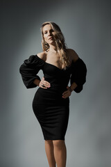 Elegant Blonde Woman in Little Black Fashion Dress