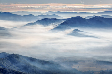 The view of the Victorian Highlands on a misty. cloudy day from Bent's Lookout, Mount Buffalo.