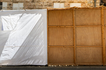 A street scene in Jerusalem during Sukkot, in which temporary, wooden or fabric structures called a sukkah are erected as part of the ritual observance of the weeklong Jewish holiday.