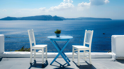 Santorini island Greece. Two white chairs with blue table