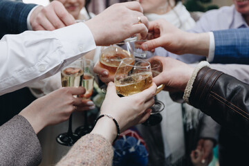 Caucasians clink glasses of champagne