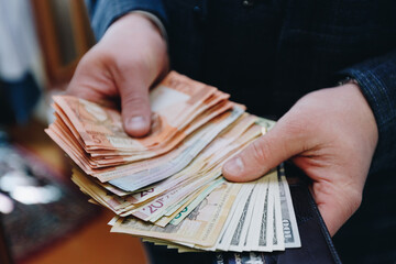 many banknotes in the hands of a caucasian
