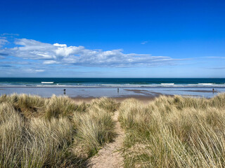 Bamburgh beach and castle, sand dunes, Northumberland coastal area, England 