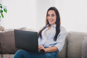 Photo of nice lady unbelievable reaction use laptop wear blue shirt bright interior flat indoors