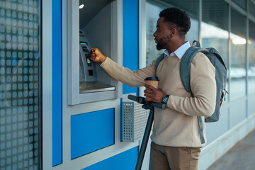 Man at ATM securing his transaction