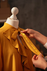 Tailor measuring ribbon on blouse collar
