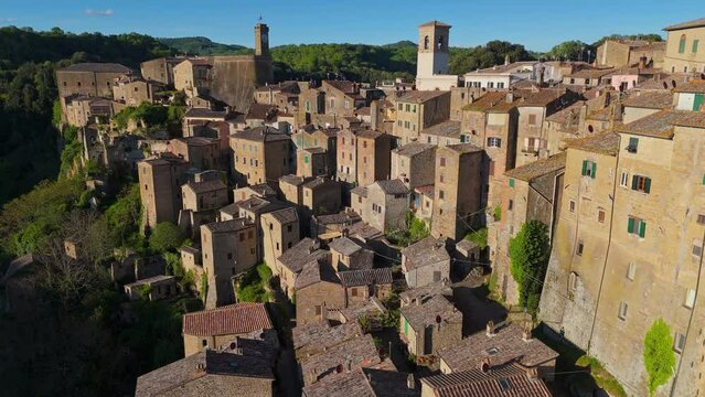 Aerial shot of ancient medieval hill town Sorano, Grosseto province, Italy. Flying over old stone houses on cliff in Sorano, southern Tuscany