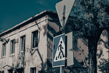 concrete pillar broken by shards and blue road sign in Ukraine - obrazy, fototapety, plakaty