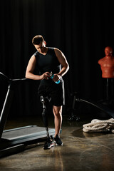 Fototapeta na wymiar A man, sporting a prosthetic leg, stands on a treadmill in a dimly lit room, focused on his workout routine.