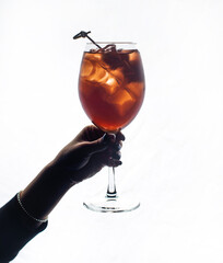 Wine glass in woman's hand . cocktail in hand. silhouette - obrazy, fototapety, plakaty