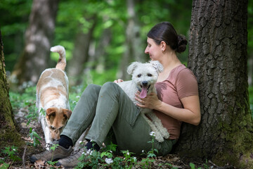 happy woman with her dogs in the forest