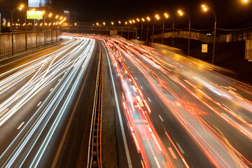 Light trails of headlights and brake lights on a highway; long exposure shot of blurred headlights...