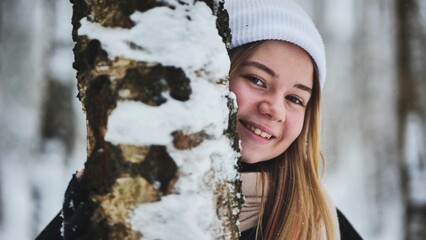 Portrait of a girl in winter in a birch forest.