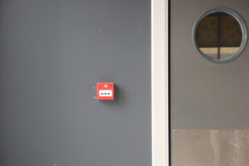 Red fire alarm button on wall ,