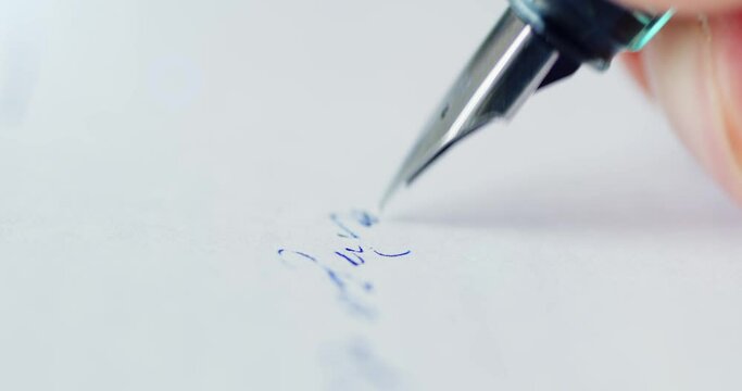 Fountain pen leaves a signature on a white paper