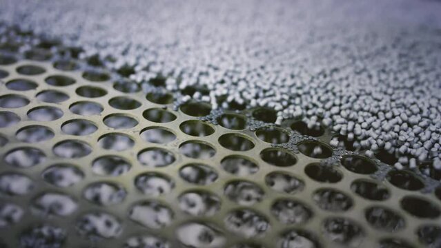 Extruder machine makes plastic granules, recycling polypropylene. Gray plastic pellets. Raw material for plastic or Polyethylene products. Garbage factory or waste plant. Recycling of plastic items