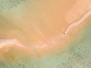 Aerial top down view of a beach with turquoise clear water in Koh Phangan Thailand