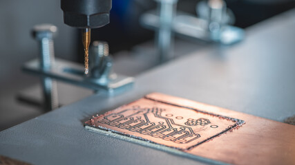 Fototapeta na wymiar machine with numerical control CNC carries out milling of printed circuit boards, Circuit Engraving, Diy Circuit Boards PCB