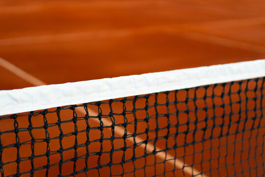 diagonal net of tennis with white stripe in orange clay court, tennis compettion concept