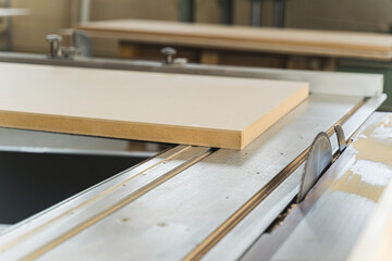 closeup view of cutting wooden planks on the machine at the carpentry. High quality photo