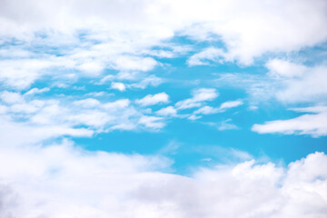 Clouds frame with small patterns on bright blue sky background