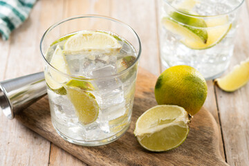 Glass of vodka tonic cocktail on wooden table