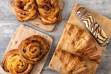 Set of bakery pastries on wooden table. Top view