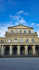 Tall city building against an electric blue sky with fluffy cumulus clouds Hanover Germany