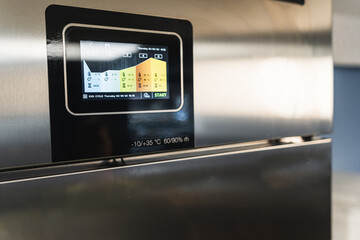 closeup shot of the fridge monitor, adjusting fridge setting to save products . High quality photo