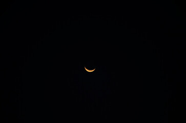 Crescent moon is in the sky with black background