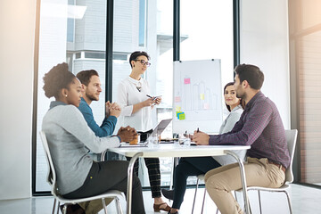 Team, woman and writing in brainstorming, office or boardroom for project as management for company or business. Group, presentation and whiteboard with sticky note and graph for presentation meeting