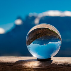 Crystal ball alpine landscape shot with Mount Schlern, dolomites, in the background near...