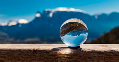 Crystal ball alpine landscape shot with Mount Schlern, dolomites, in the background near...