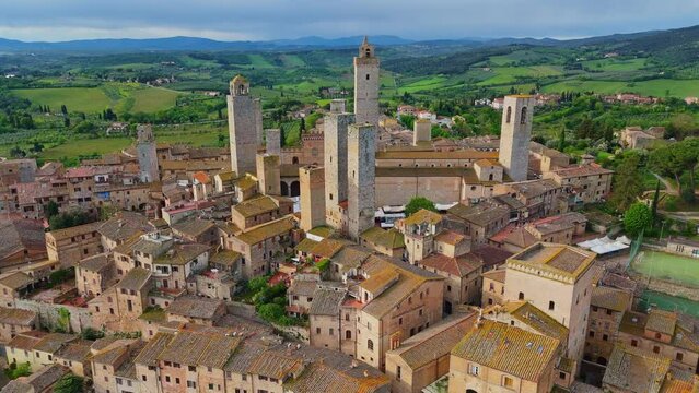 Flying over medieval town of San Gimignano, Tuscany, Italy. Aerial view of old stone towers in San Gimignano