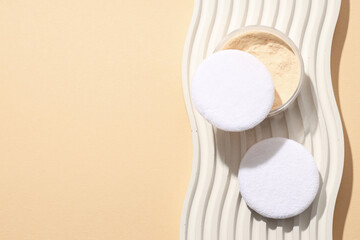 A bottle of powder, light shade, on a beige background.