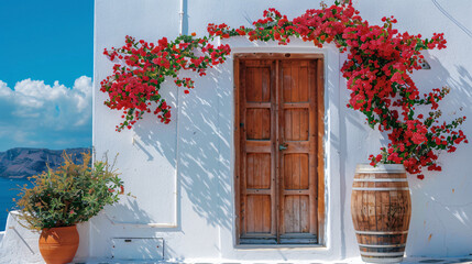 Wooden door with flowers. White cycladic architecture - obrazy, fototapety, plakaty