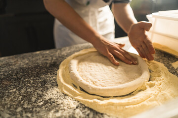 Pizza Process Dough Preparation Close-up shots of the hands kneading and stretching pizza dough on...