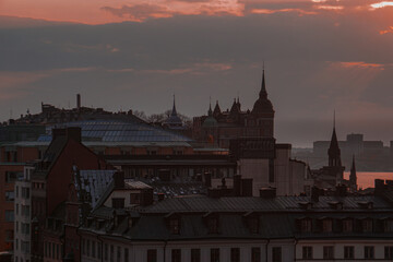 View of buildings in city against red sky