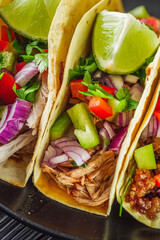 set of delicious juicy tacos on black wooden rustic background