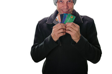 Portrait of happy young man showing plastic credit cards on white background. Digital transactions: Person holding credit and debit cards, perfect for e-commerce graphics