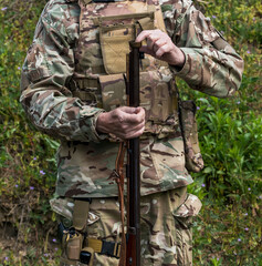 Army soldier loading a handgun
