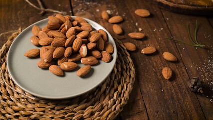 Scattered almonds on a wooden surface
