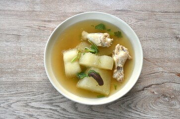 boiled winter melon drumstick chicken with mushroom soup on plate  