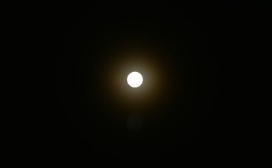 bright yellow full moon floating on sky in night background