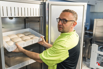 preparing pizza dough balls to make pizza later, restoring dough in the fridge. High quality photo