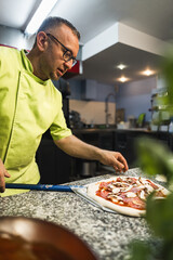 chef preparing pizza to put it in an oven, kitchen concept. High quality photo