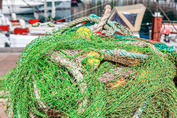 Pile of fishing nets on the quayside of the port