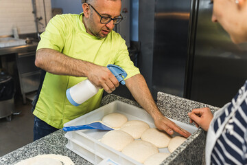 The chef Pizza maker checks that the dough is ready, the dough balls. High quality photo