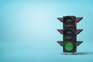Green light on stack of black loudspeakers