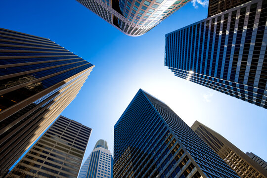 Glass and concrete facades of high-rise buildings in the financial district in downtown San Francisco, California (USA) from a worm's perspective with vanishing point on a sunny day with blue sky.